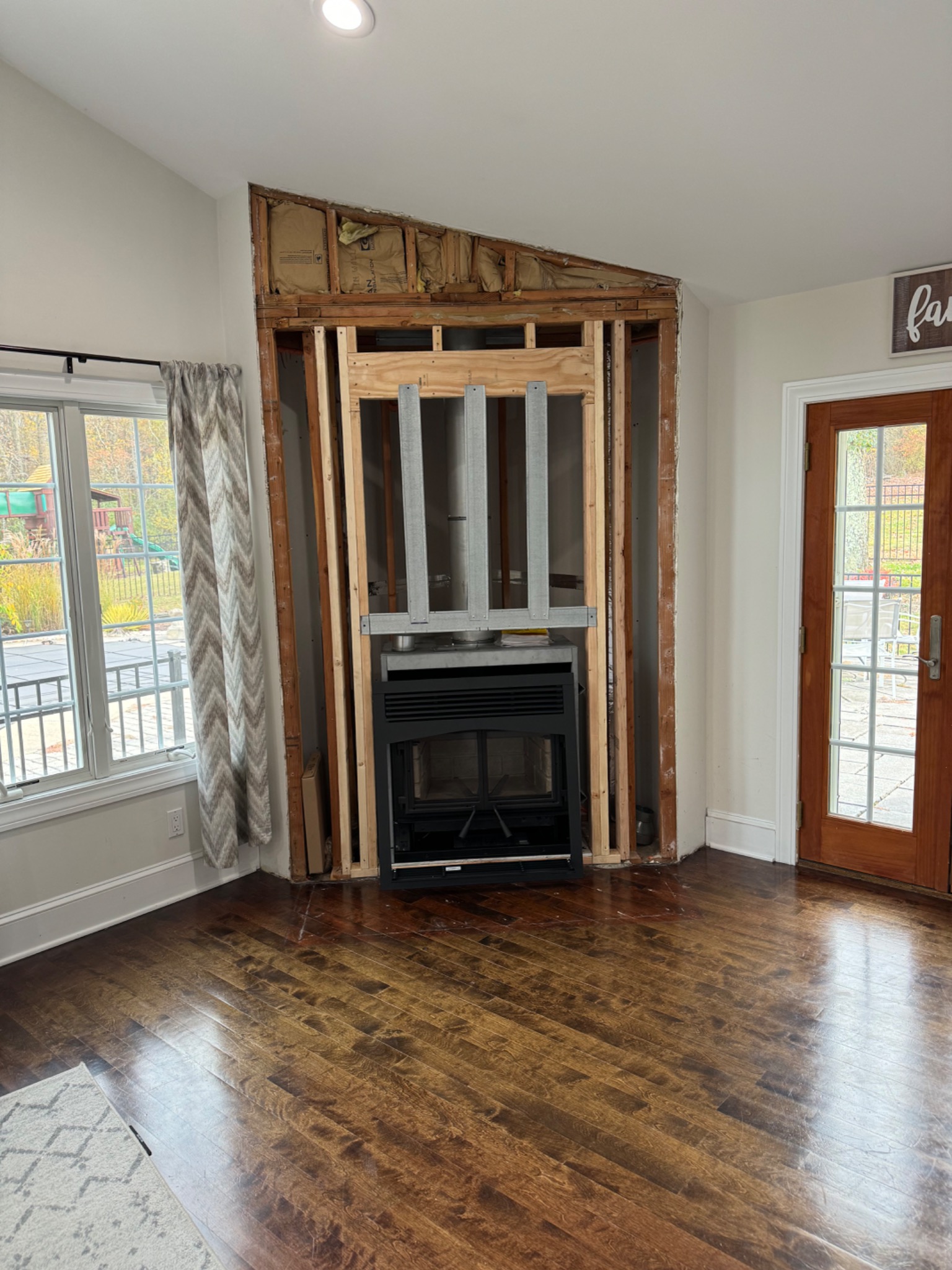 During: Majestic wood fireplace installation framing